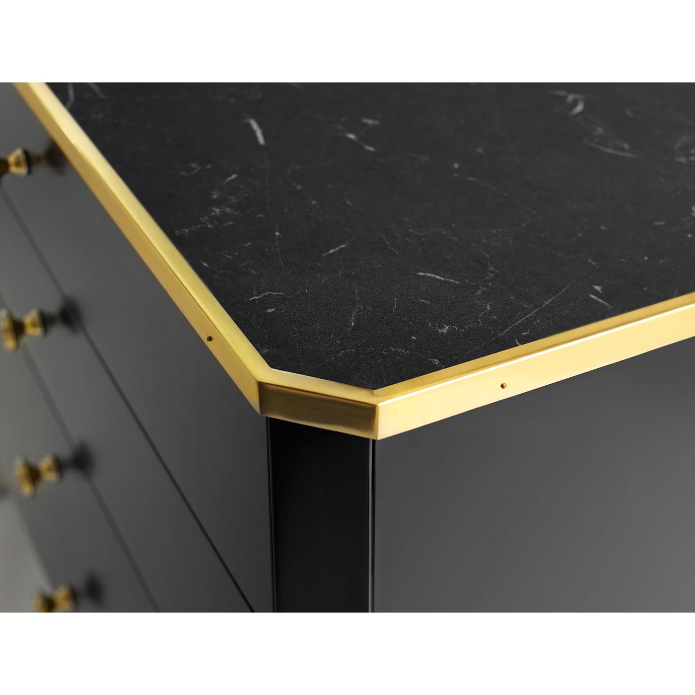 Black mid-century nightstand corner detail with gold edge.
