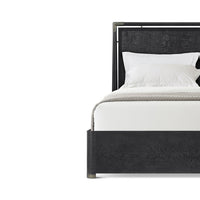 Close-up of black mid-century bed headboard, pillows visible.