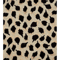 Close-up of black ocelot cube ottoman fabric pattern.