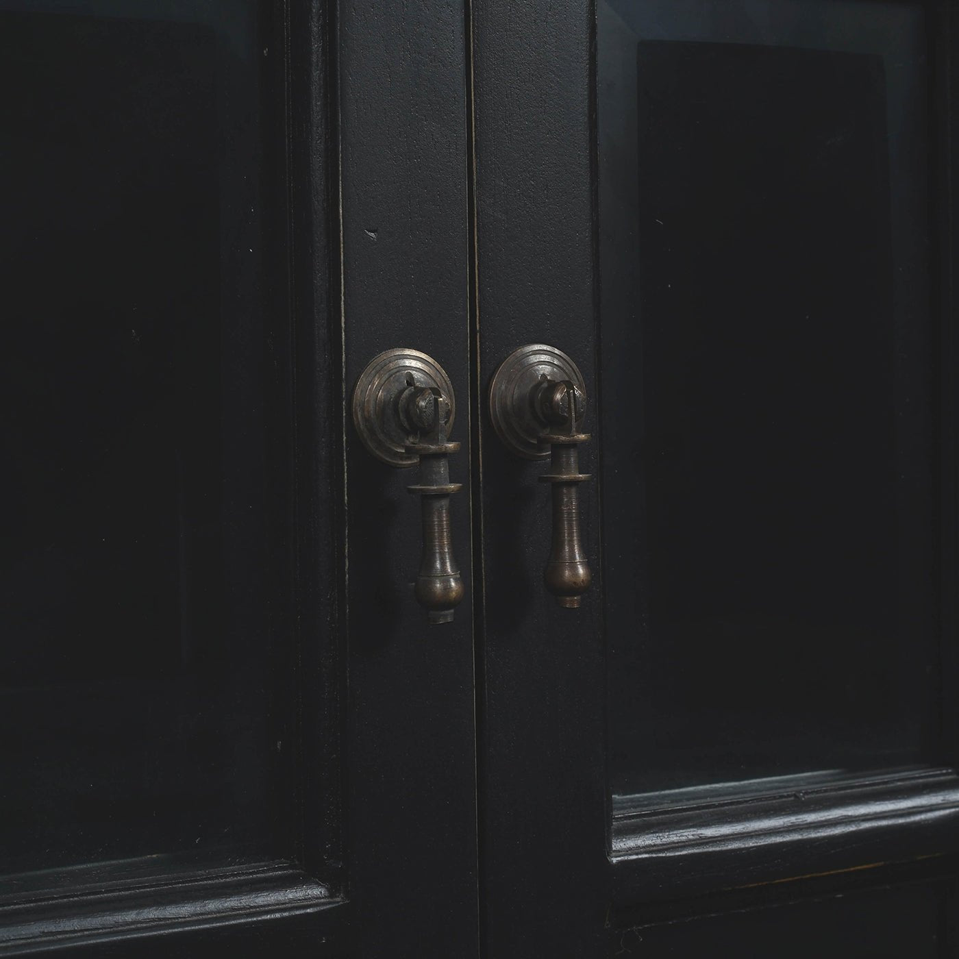 Black display cabinet, close-up of handles.