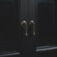 Black display cabinet, close-up of handles.