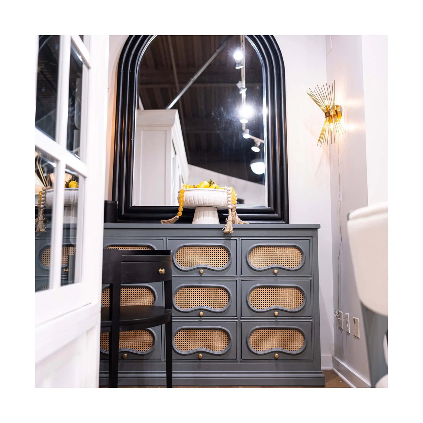 Black oval side table in modern room setting.