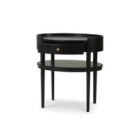 Black oval side table side angled view.