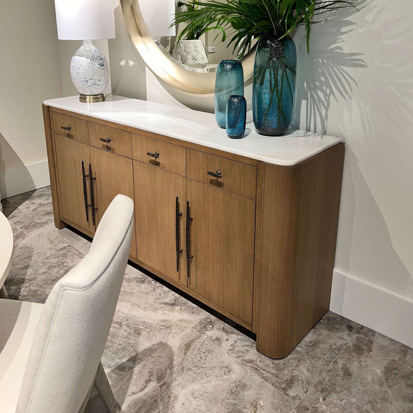 Buffet sideboard in living room with decorative accessories.