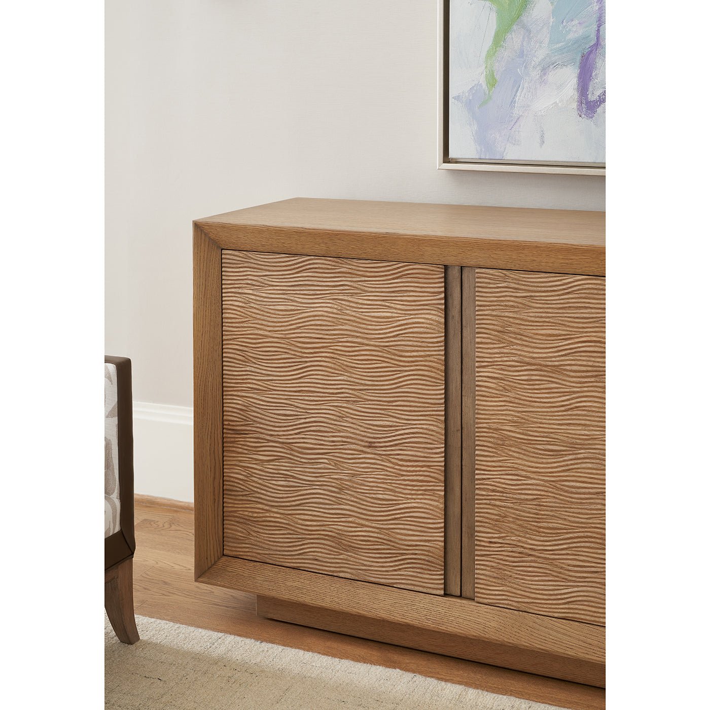 Media cabinet in elegant interior space with contemporary art.