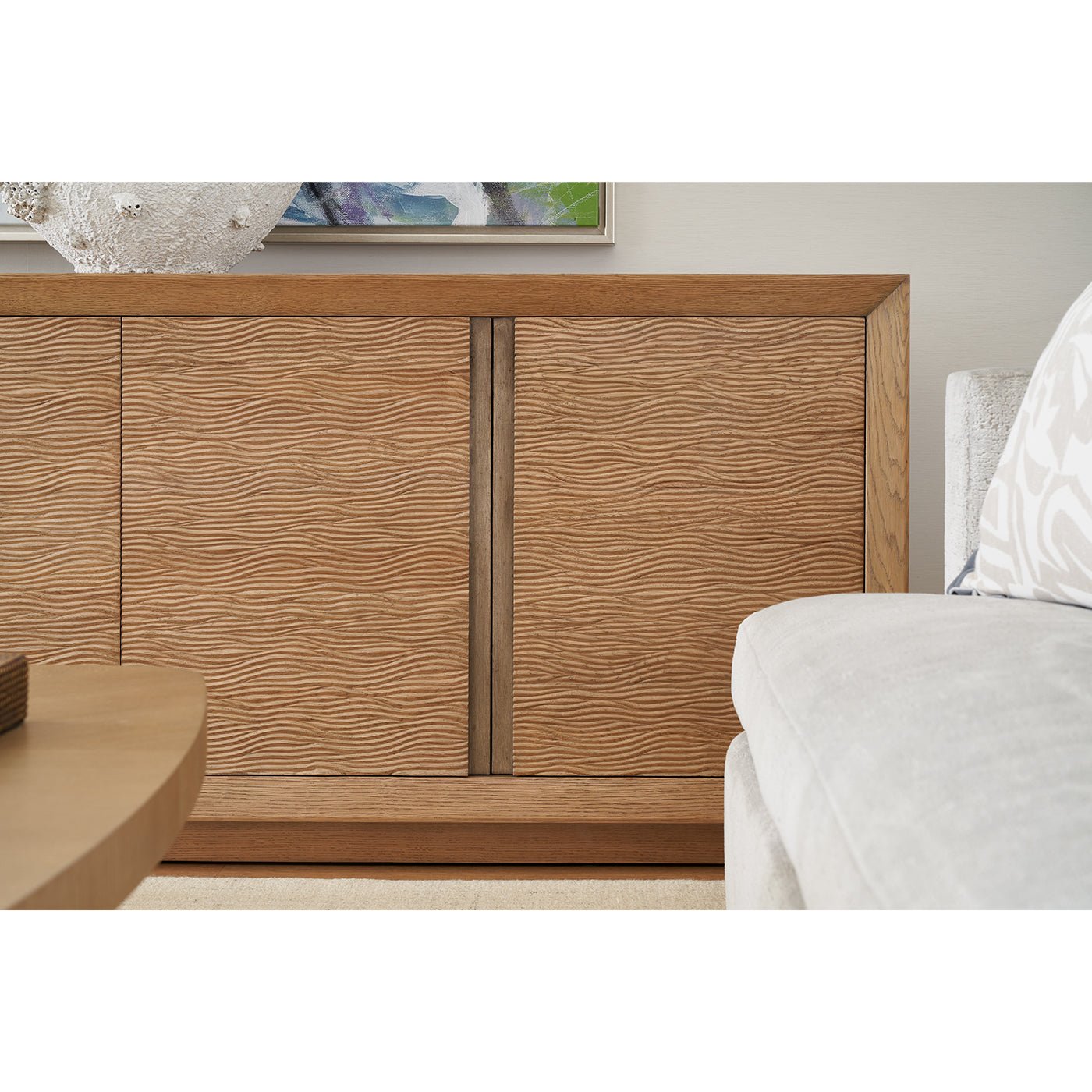 Textured media cabinet beside sofa and coffee table.