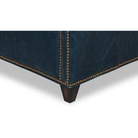 Wood legs and nailhead trim on blue accent chair