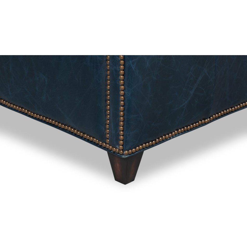 Wood legs and nailhead trim on blue accent chair