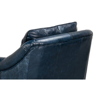 Back cushions of blue leather accent chair