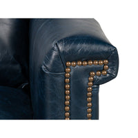 Armrest detail of blue leather accent chair
