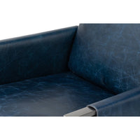 Inside view of armrest, blue leather accent chair.