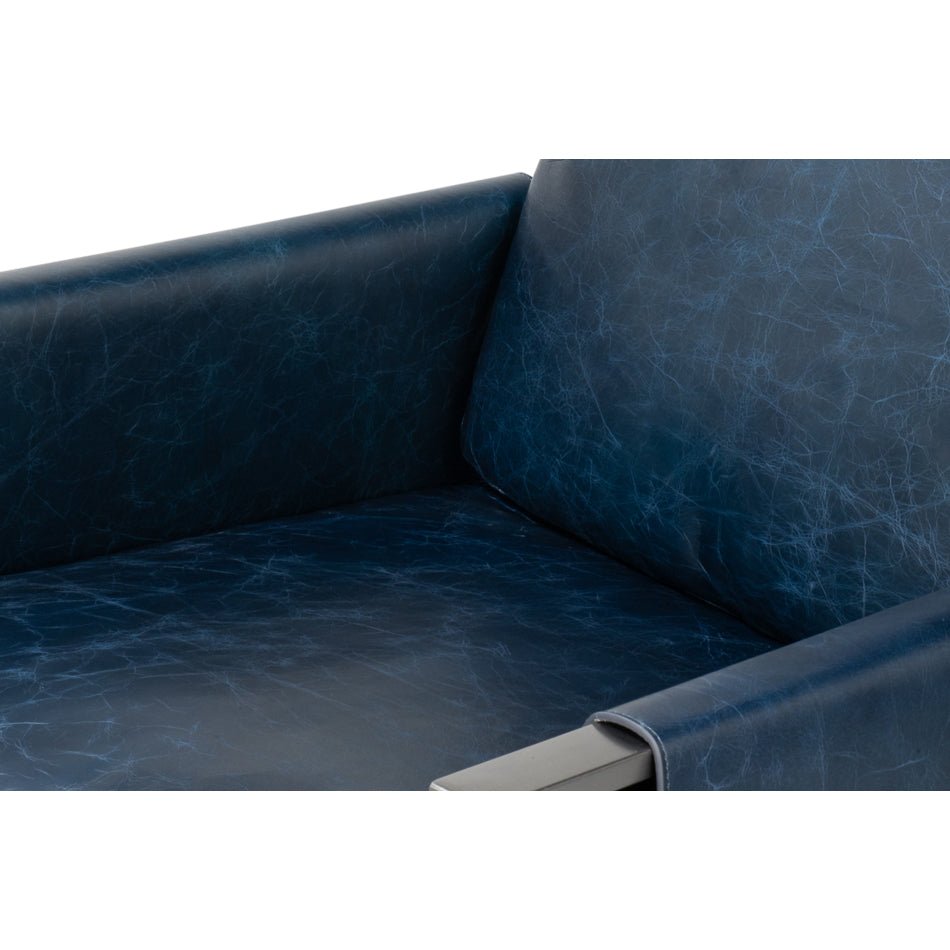 Inside view of armrest, blue leather accent chair.