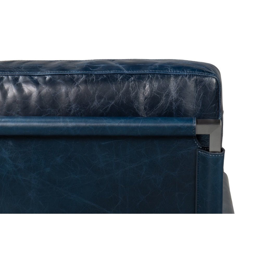Upper back view, blue leather accent chair.