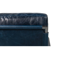 Upper back view, blue leather accent chair.