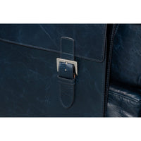 Detail of buckle on accent chair, blue leather.