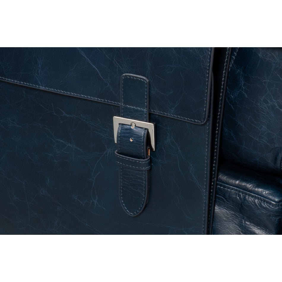 Detail of buckle on accent chair, blue leather.