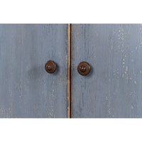Close-up of blue sideboard door knobs.