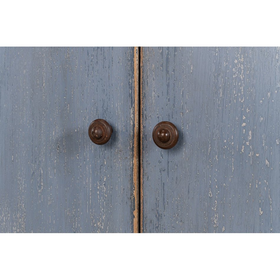 Close-up of blue sideboard door knobs.