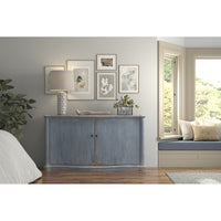 Room with blue sideboard, decor and window seat.