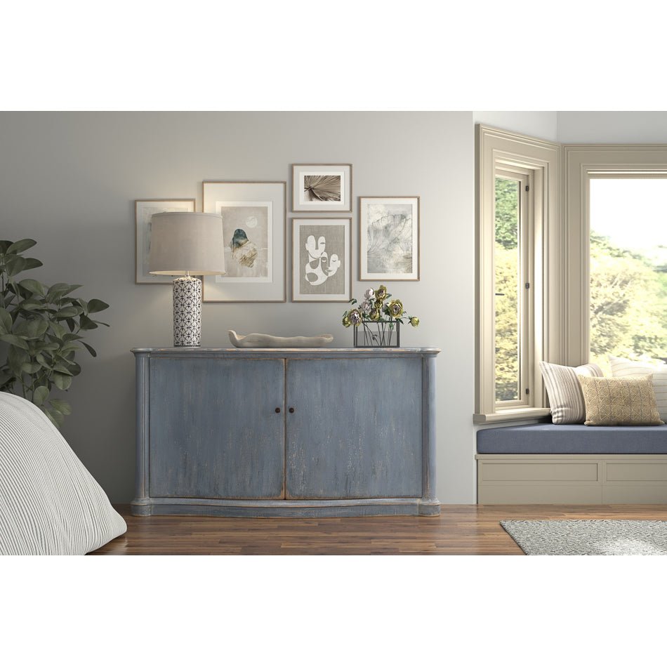 Room with blue sideboard, decor and window seat.