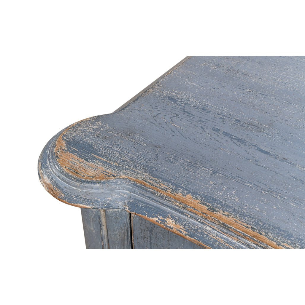Worn top corner detail of blue sideboard.
