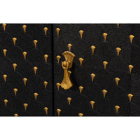 Close-up of gold hardware on sideboard.