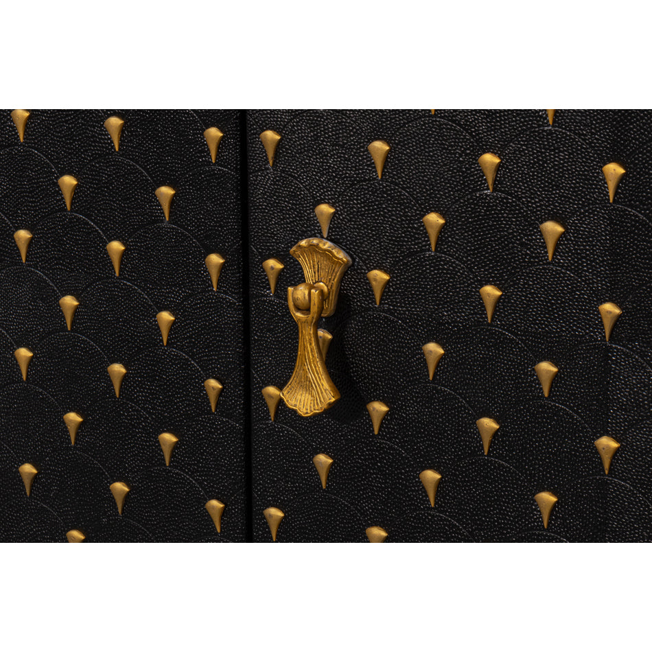 Close-up of gold hardware on sideboard.