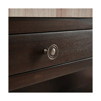 Close-up of drawer handle on dark kitchen island.