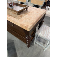 Top view of butcher block kitchen island and stool.