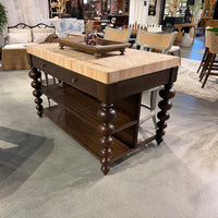 Angled showroom view of bobbin leg kitchen island.