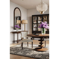 Console table in dining room with mirror and chairs.