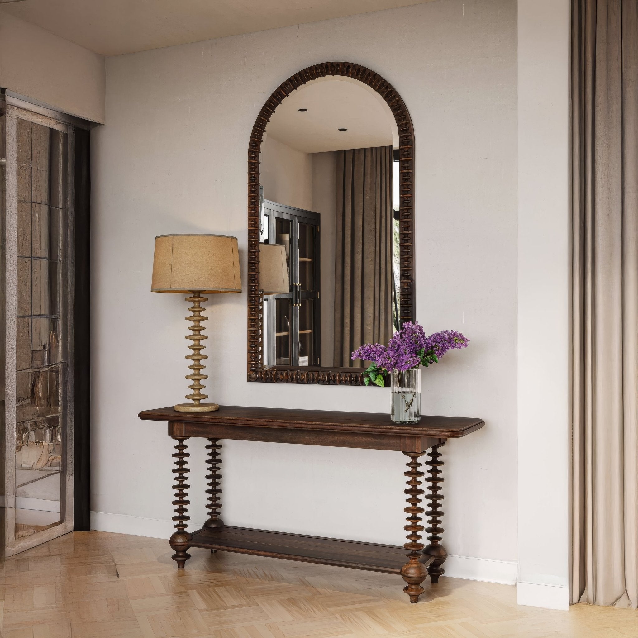 Console table styled in entryway with mirror and lamp.