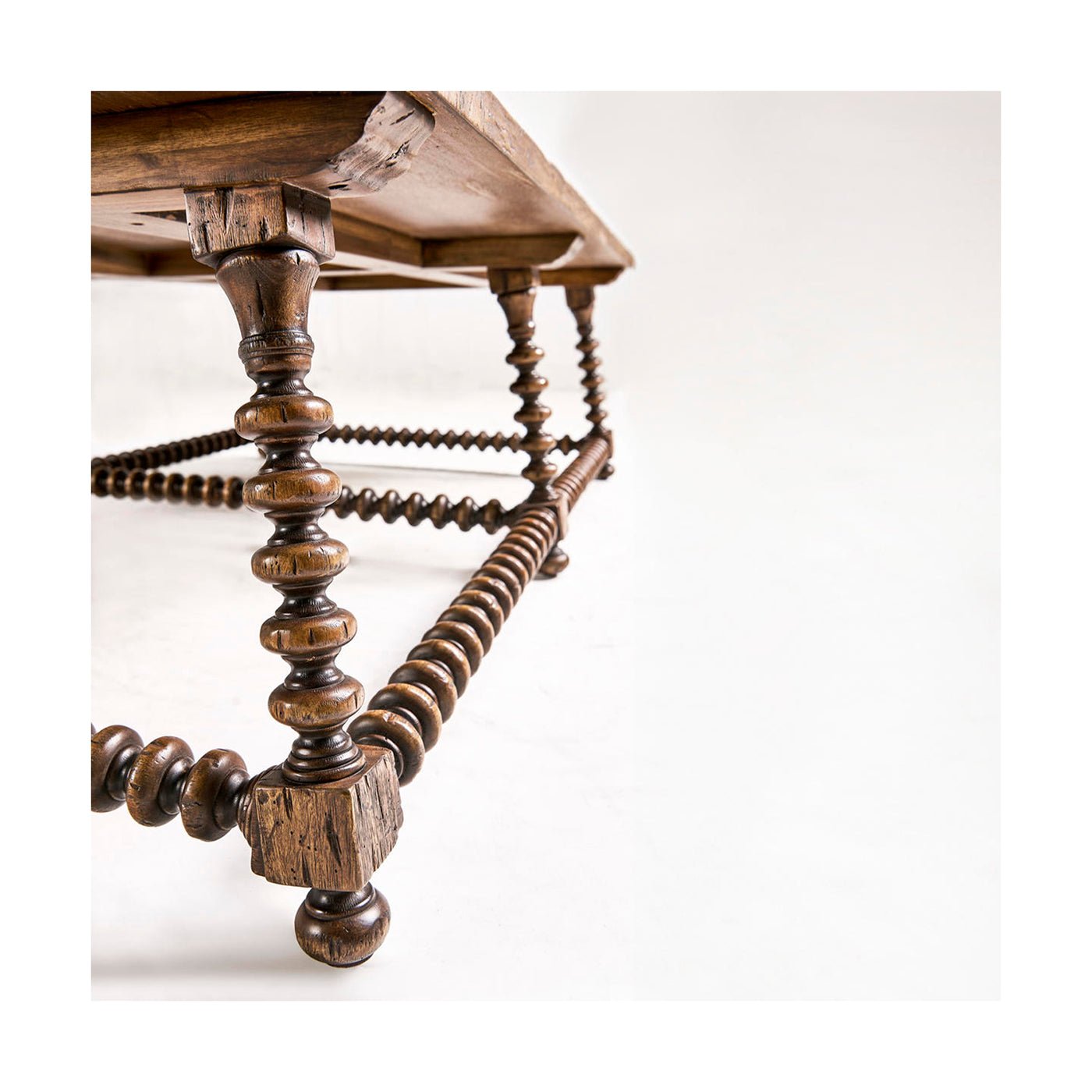 Low angle showing bobbin-turned legs and table structure.