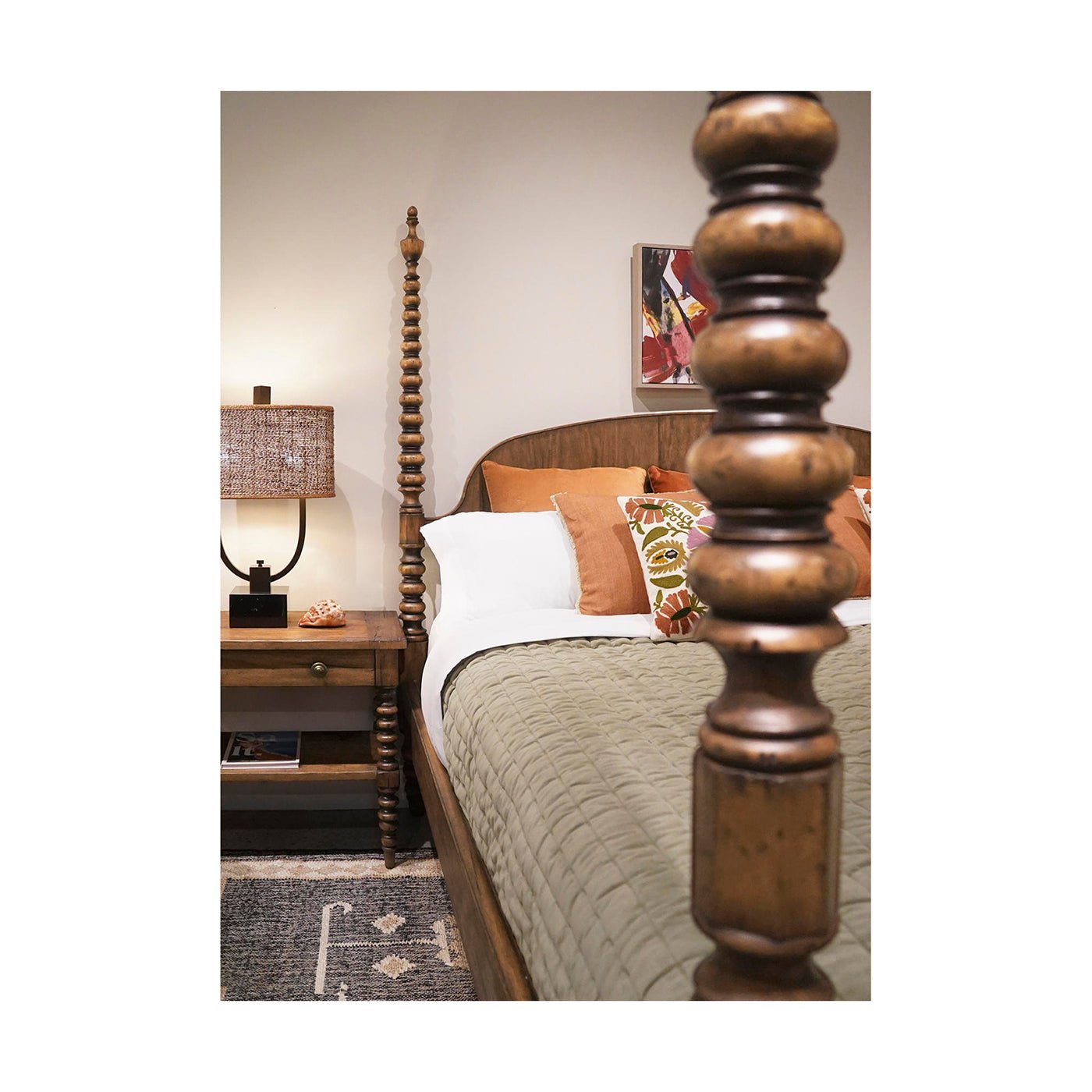 Bedroom with bobbin-turned bedpost and rustic nightstand.