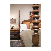 Bedroom with bobbin-turned bedpost and rustic nightstand.