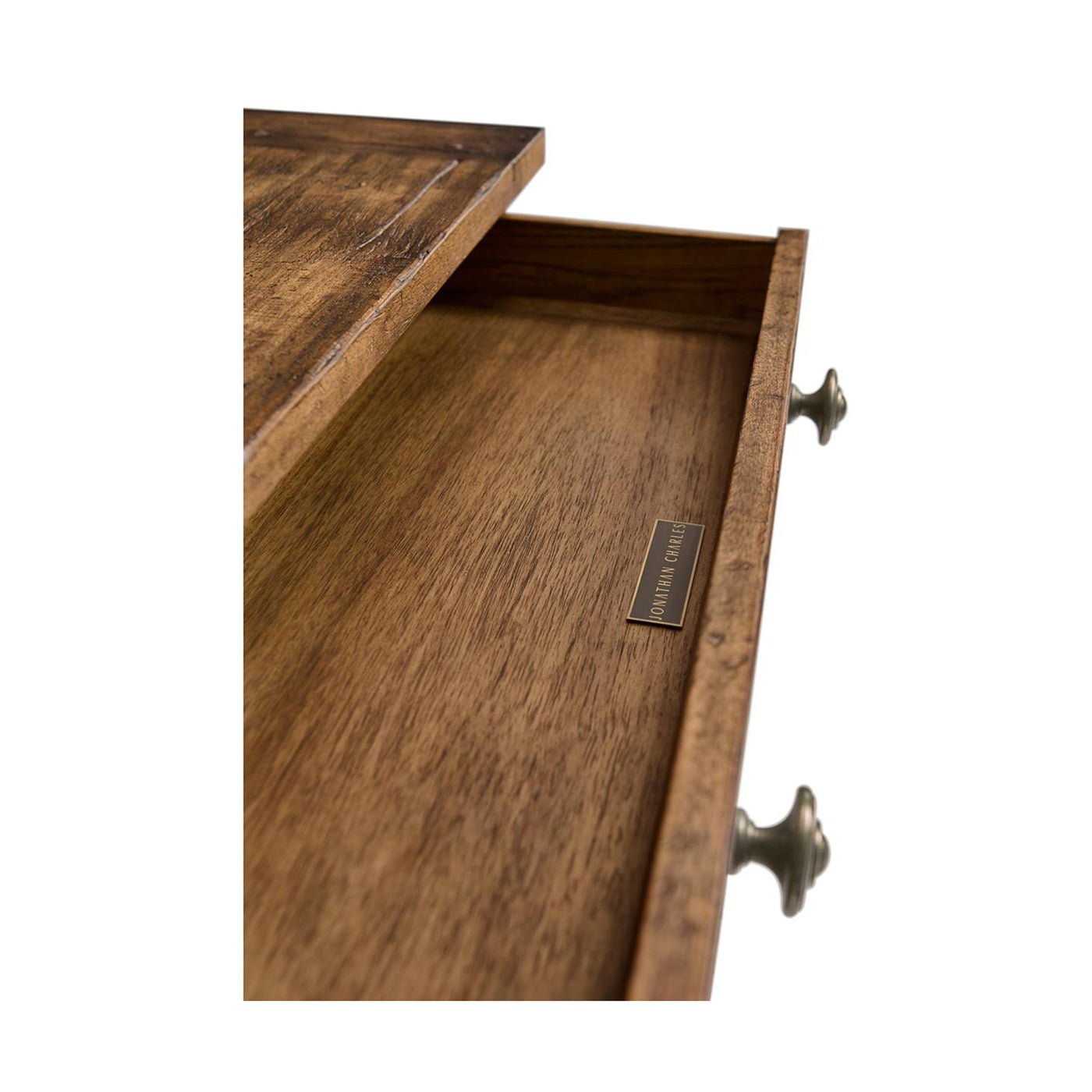 Open drawer with wooden interior of rustic nightstand.