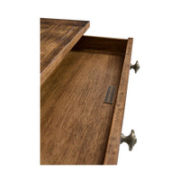Open drawer with wooden interior of rustic nightstand.