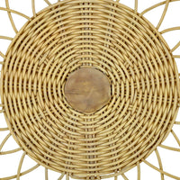 Close-up woven pattern on rattan chair backrest.