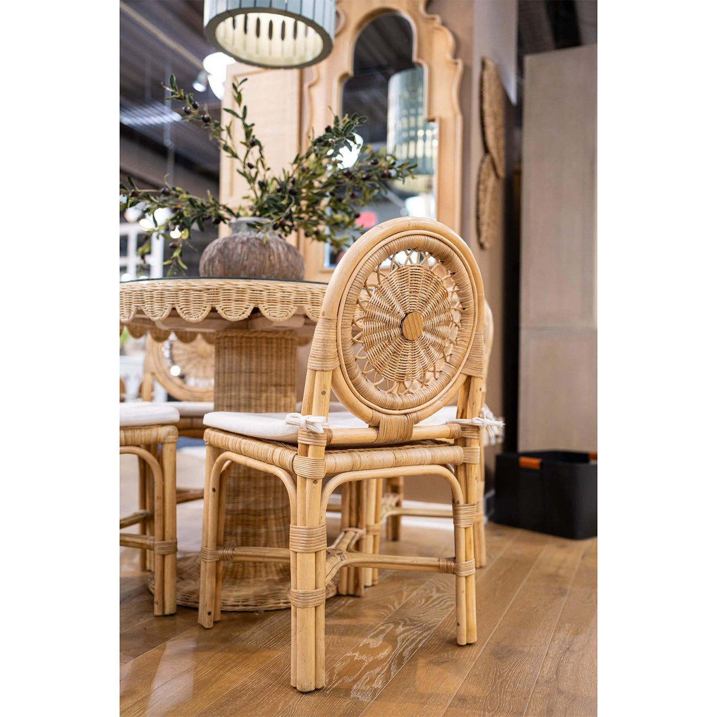 Rattan side chair in dining setting with cushion.