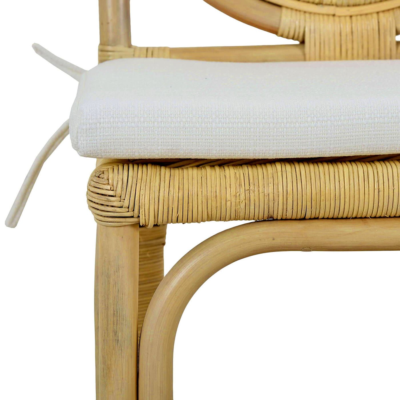 Chair seat with cushion detail on rattan side chair.