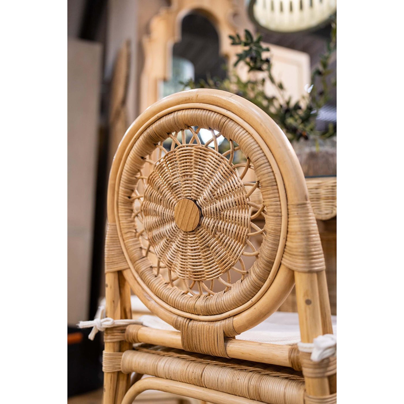 Backrest detail of rattan chair in dining area.