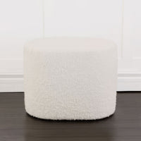 Round boucle ottoman against white background.