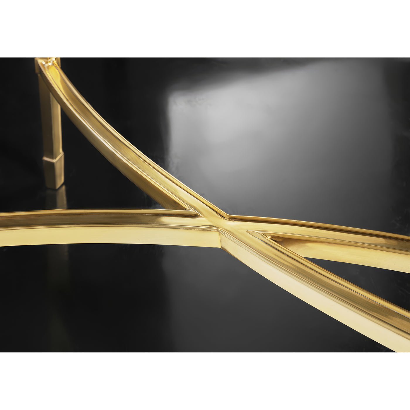 Brass mid-century console table base detail, crisscross design.