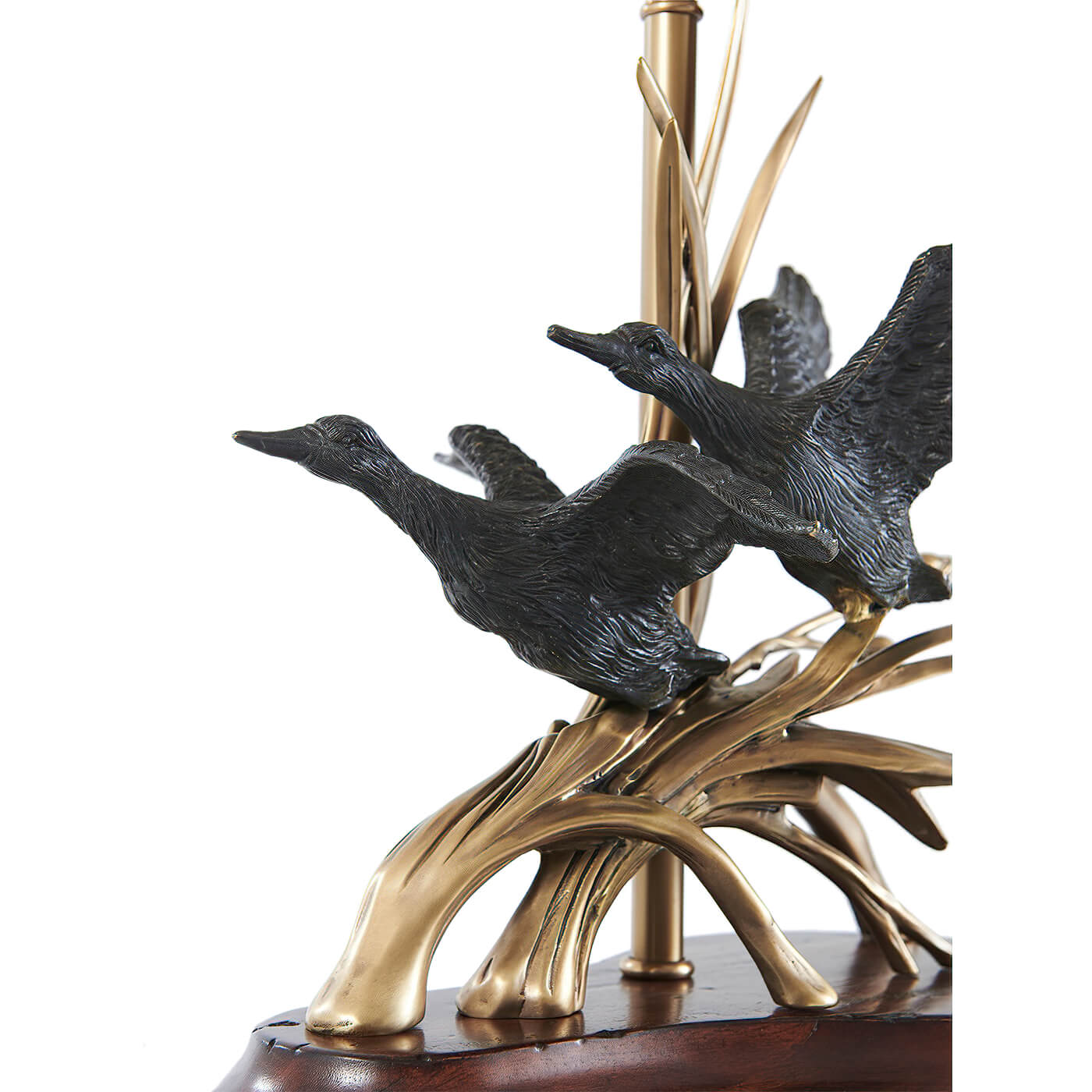 Detailed view of ducks in flight on lamp.