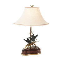 Elegant brass duck table lamp with fabric shade.