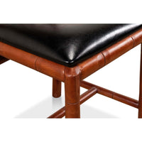 Close-up of faux bamboo chair, seat corner detail.