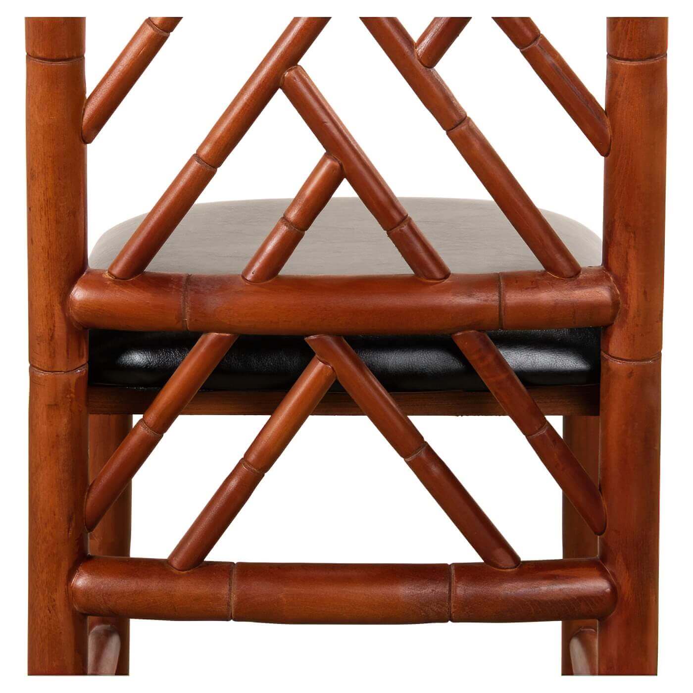Close-up of faux bamboo chair's back, intricate design.