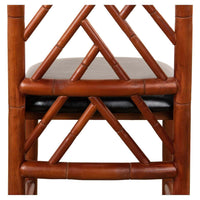 Close-up of faux bamboo chair's back, intricate design.