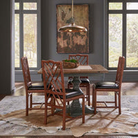 Dining room with faux bamboo side chairs around table.