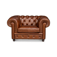 Front view, brown leather Chesterfield armchair, tufted detailing